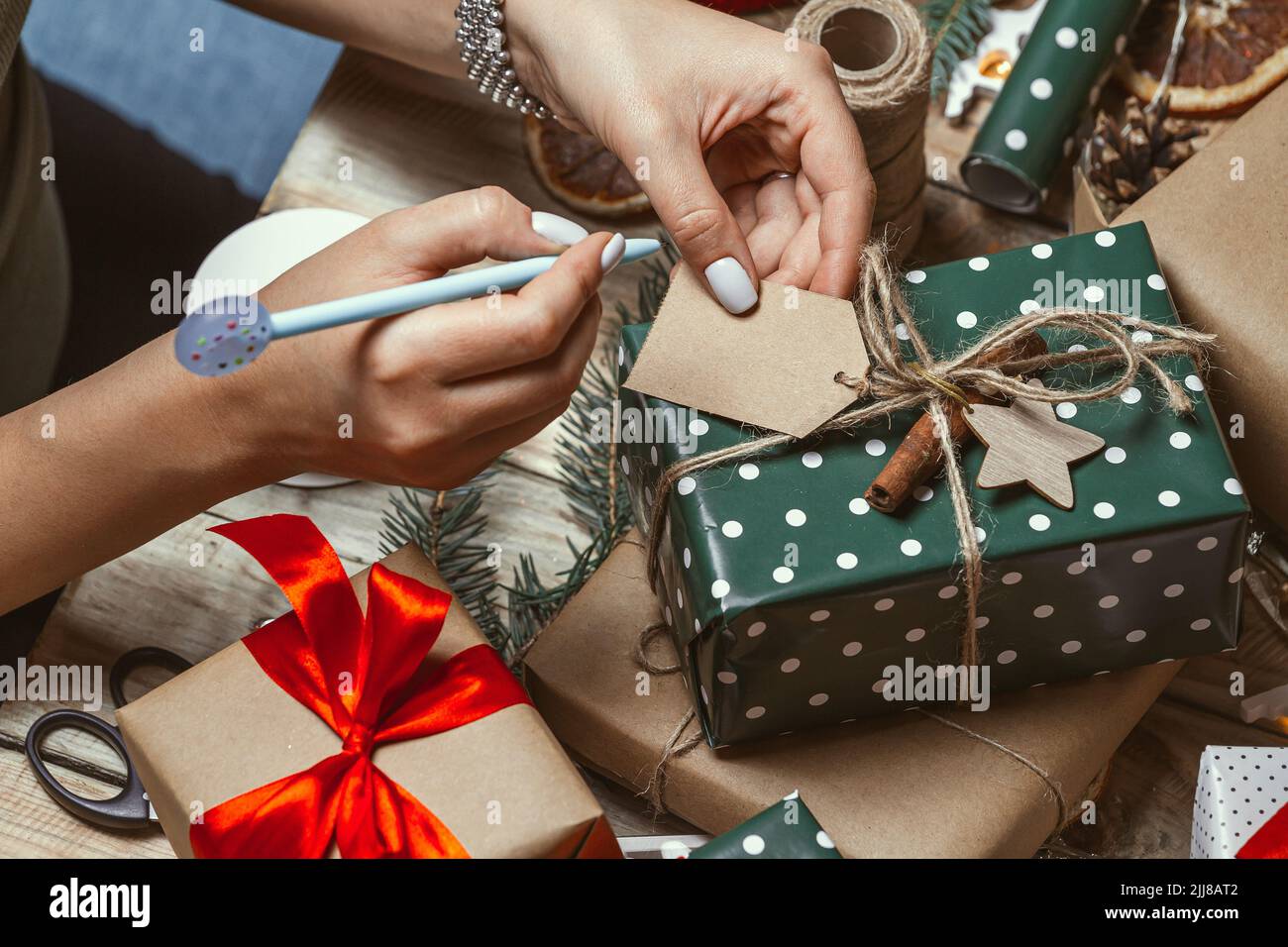 Young woman wrapping, adds up and signs the name a lot of stack Stock Photo