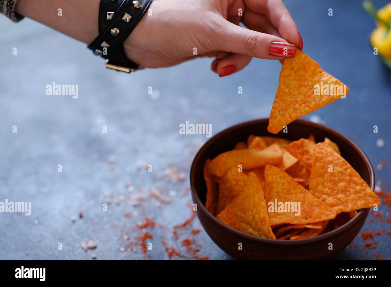 junk fast food eating nacho chips hand hold crisp Stock Photo