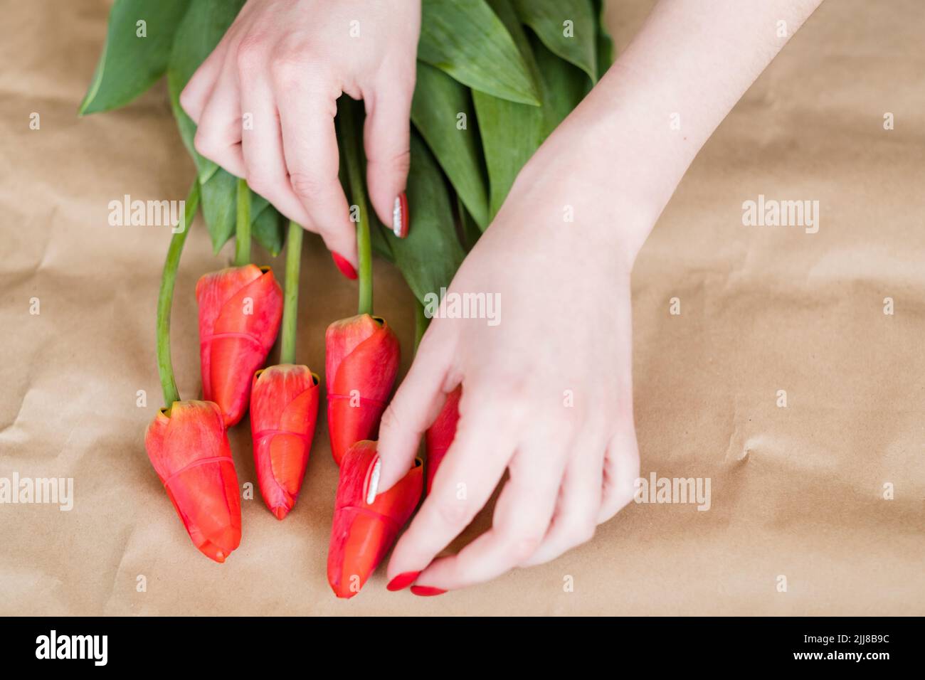 florist work flower arranging red tulip bouquet Stock Photo