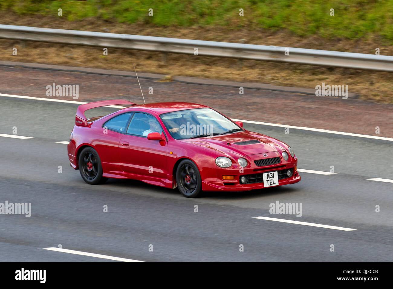 1995, 1990s nineties red TOYOTA CELICA GT4 2000cc Petrol; travelling on the M6 motorway, UK Stock Photo