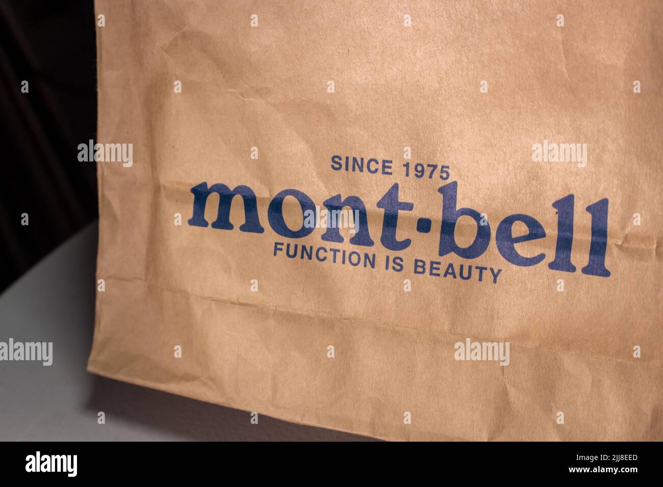 Closeup logo of Montbell (Mont-bell), Japanese outdoor clothing and equipment manufacturer and retailer, printed on a paper shopping bag. Stock Photo