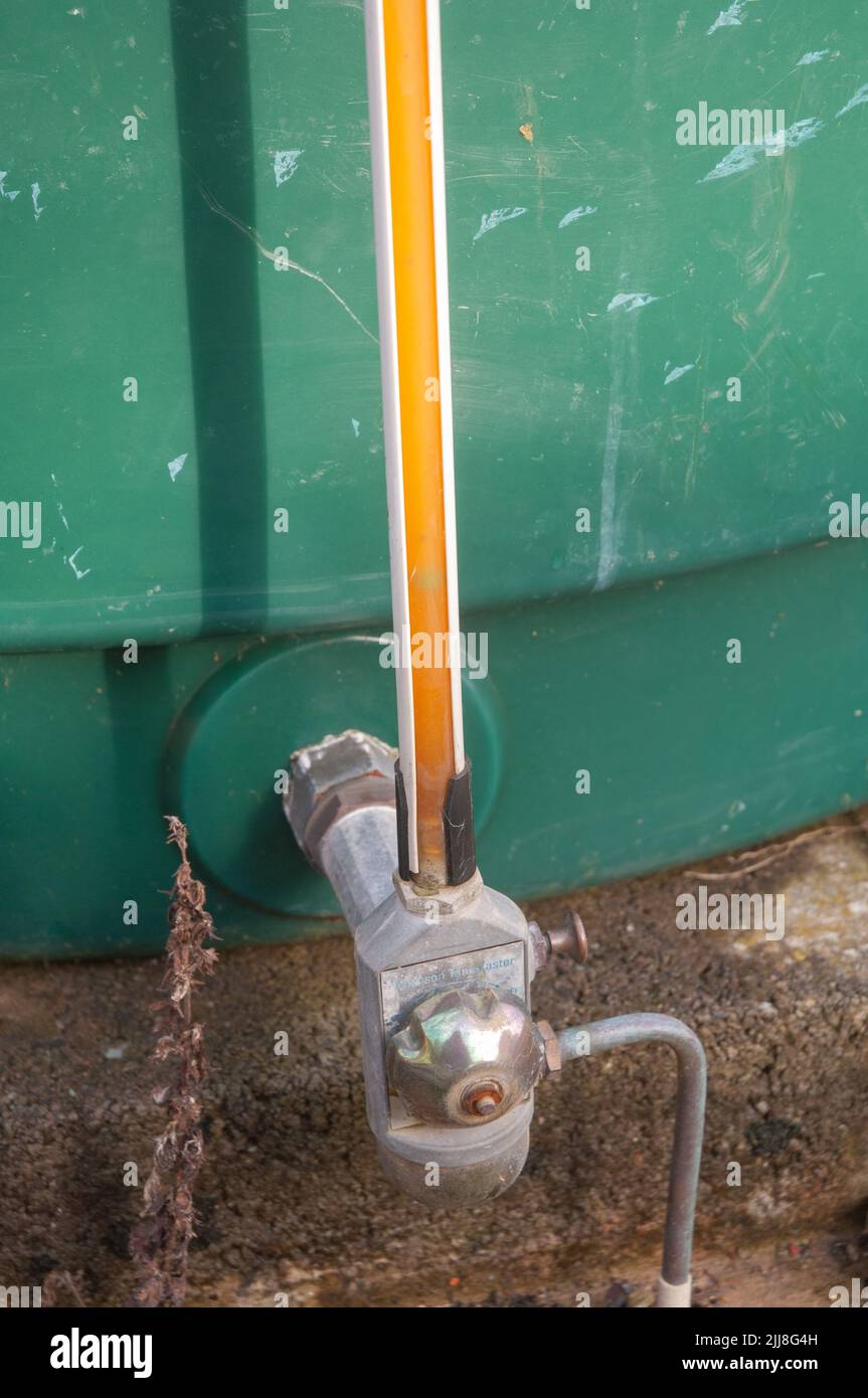 Float in tuble indicating low oil level in tank Stock Photo
