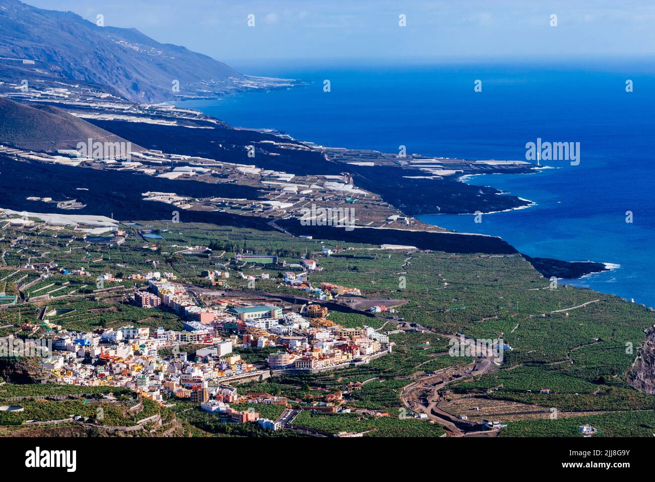 The town of Tazacorte surrounded by banana plantations. Behind the river of solidified lava that crosses the Aridane valley. La Palma, Canary Islands, Stock Photo