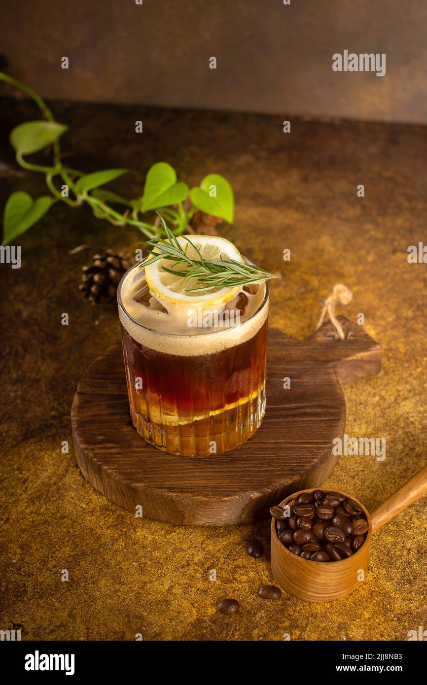 iced coffee with lemon sparkling water on rustic coaster and with