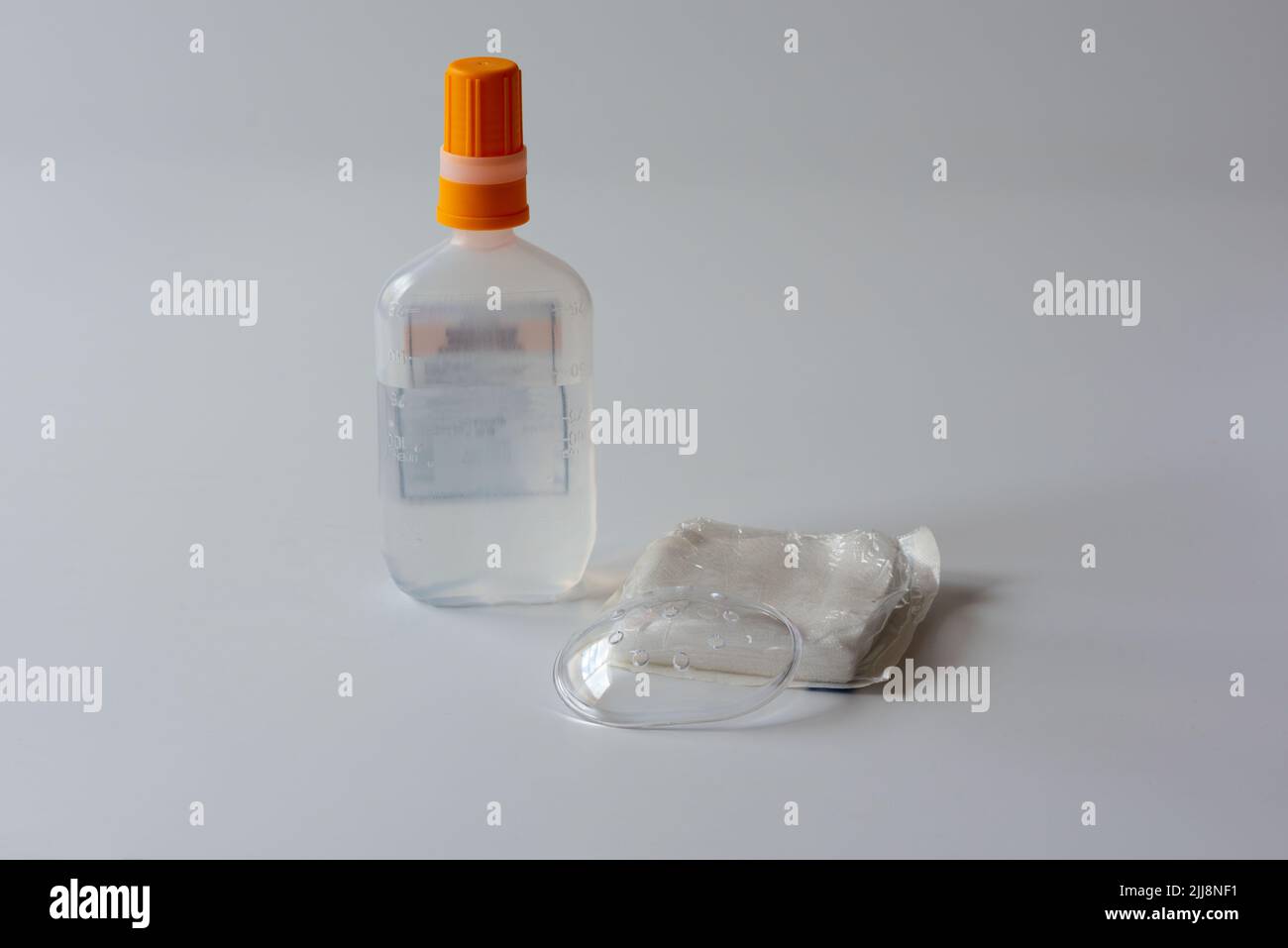 A clear plastic protective eye shield , a package of gauze and normal