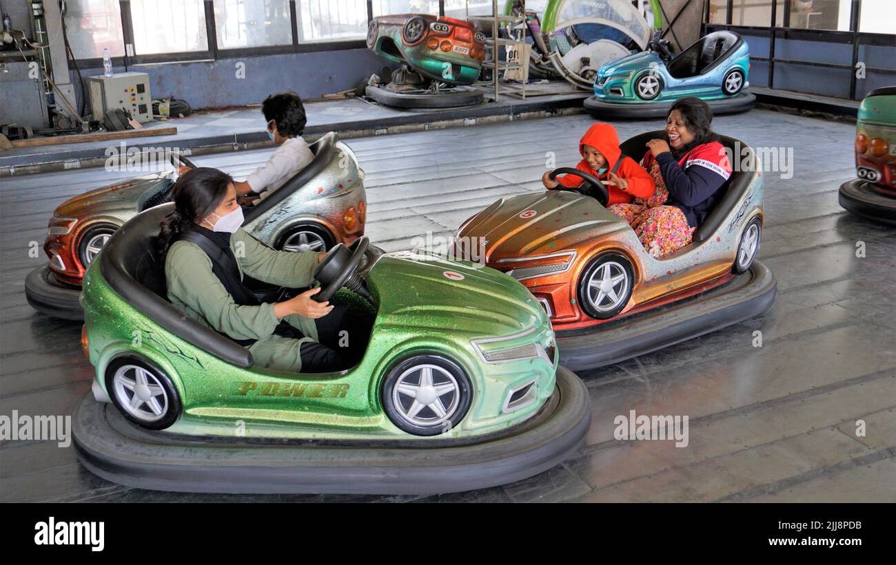 Ooty,Tamilnadu,India-April 30 2022: Young children enjoying adventurous fun dashing car inside the kids park of Ooty boat house. Stock Photo