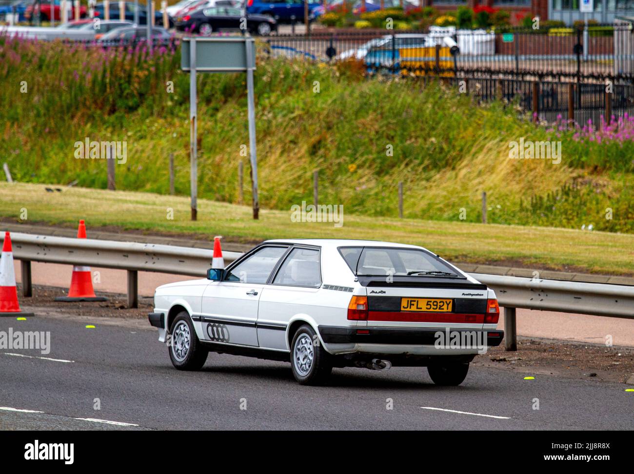 A 1982-83 Audi fuel Injection coupe car travelling along the Kingsway West dual carriageway in Dundee, Scotland Stock Photo