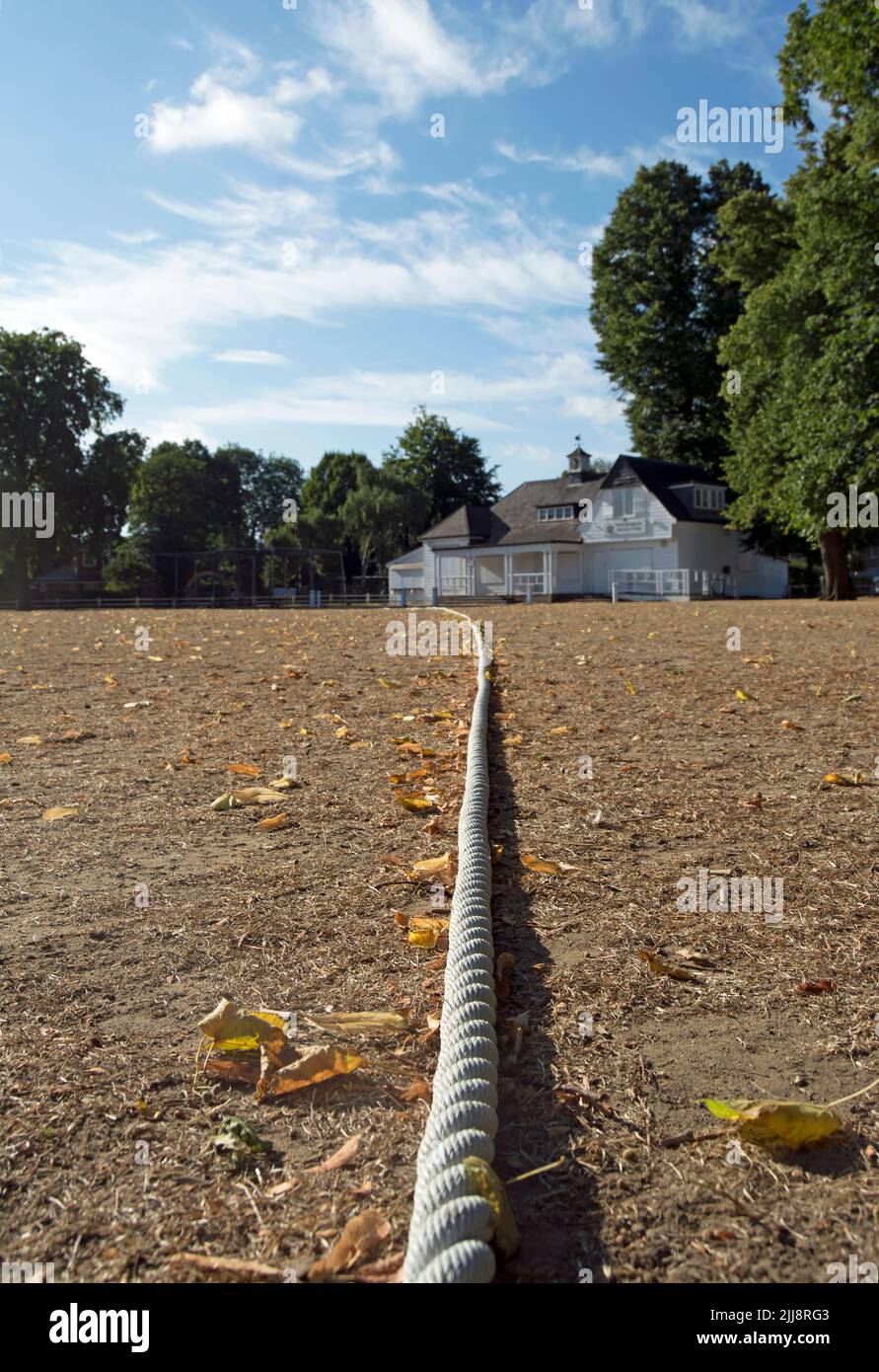 boundary rope on parched earth at twickenham cricket club, twickenham, middlesex, england, during the hot and dry july of 2022 Stock Photo