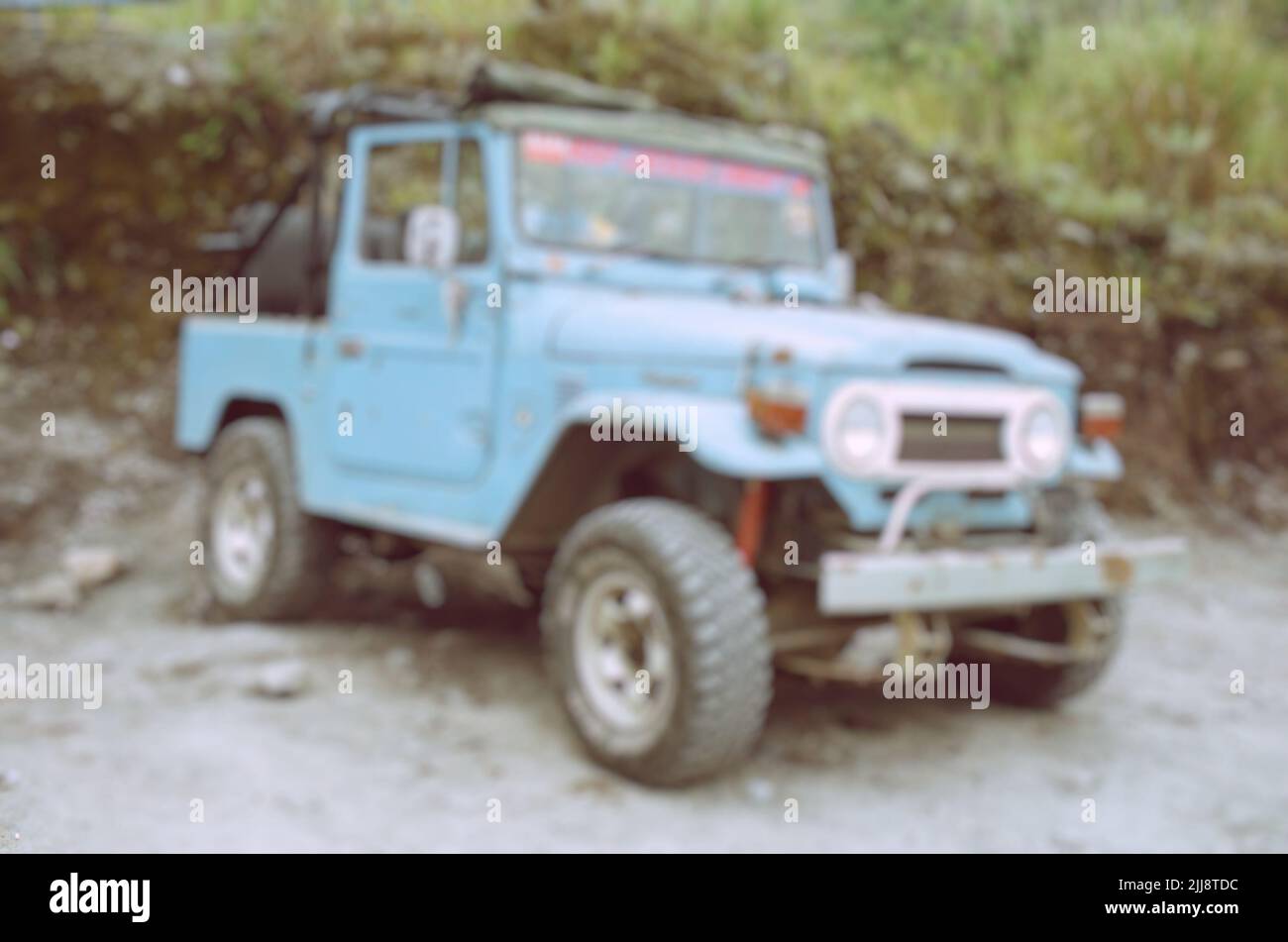 Blurry view of broken classic jeep parked in outdoor at Mount Merapi. Use for background or backdrop. No people. Stock Photo
