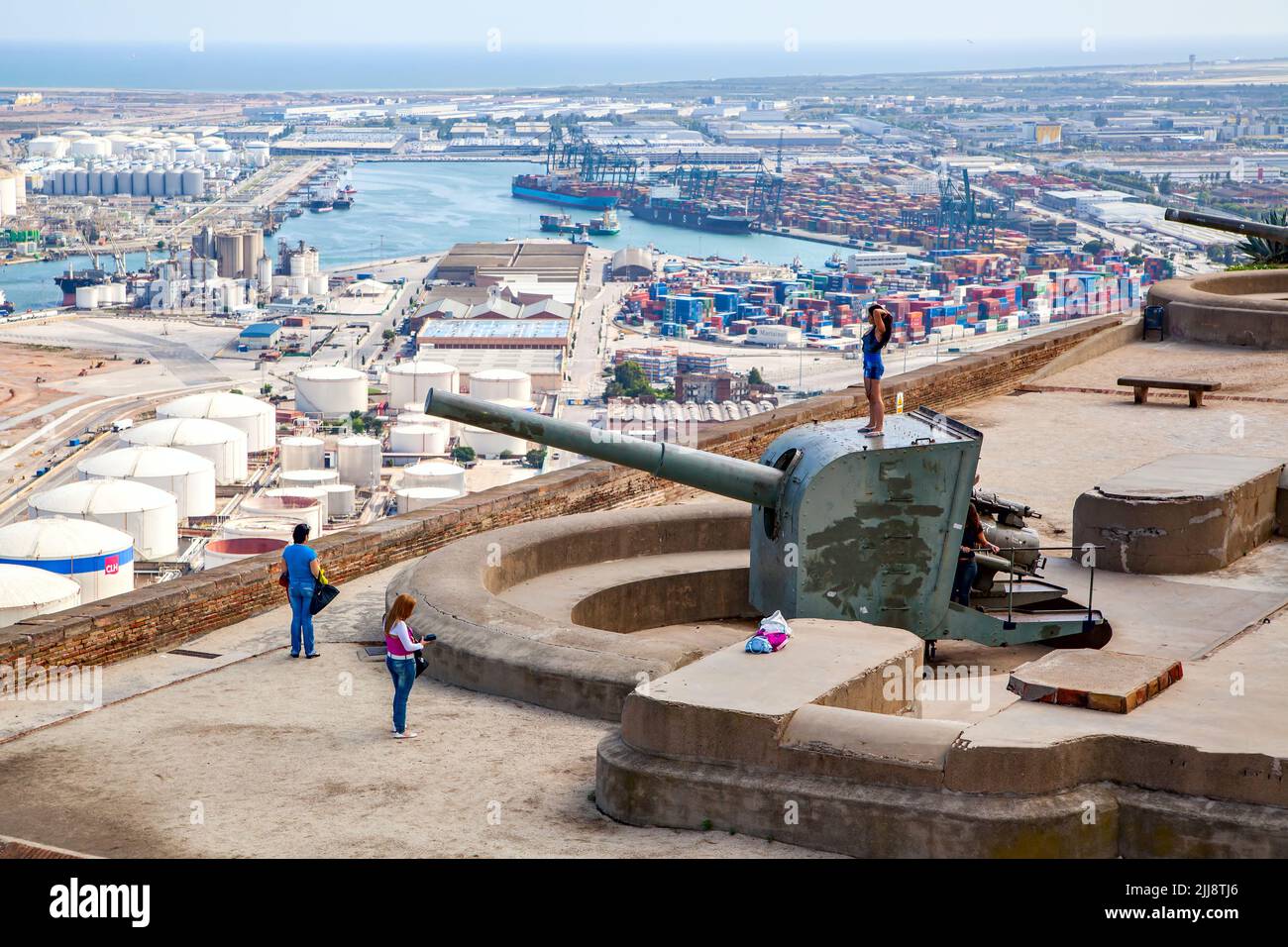 Barcelona, Spain - June 11, 2011: Panoramic view with old cannon in Montjuic fortress and cargo port of Barcelona Stock Photo