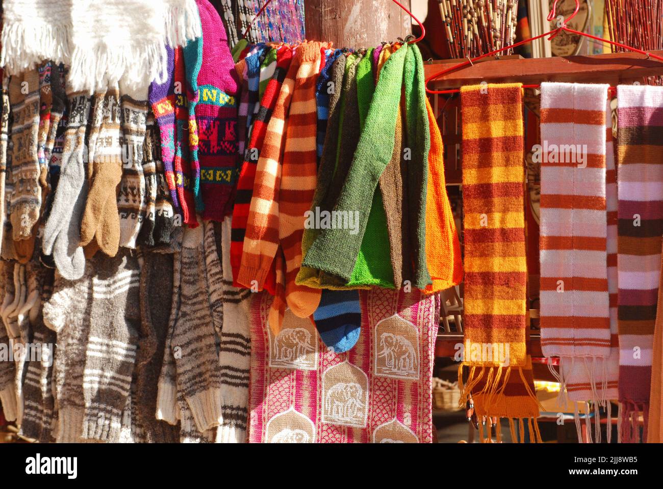 Close-up of alpaca wool beanies, scarves, and gloves on display at a craft store in Southern Chile. Stock Photo