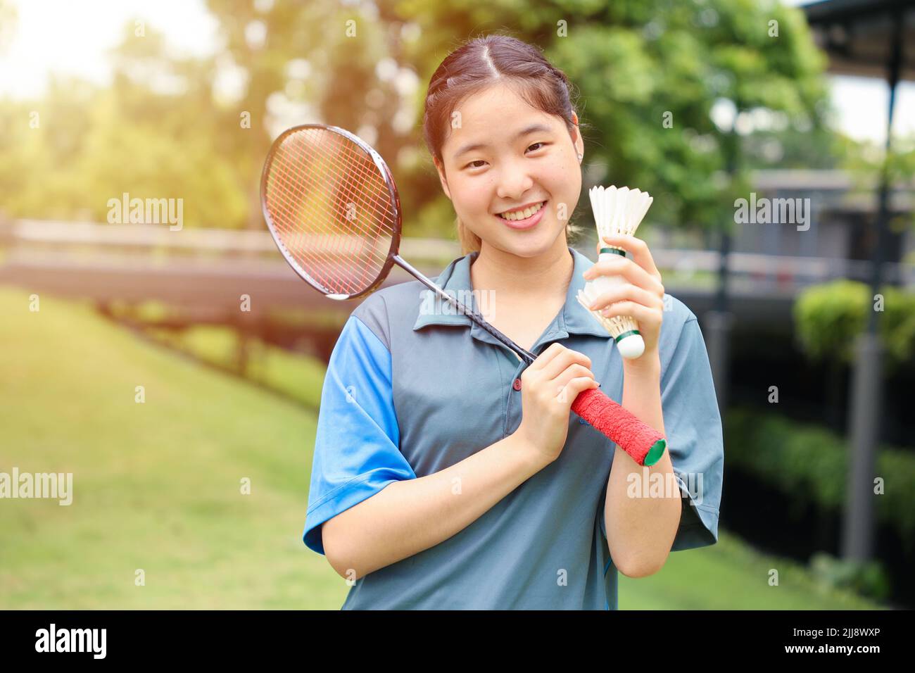 Asian Teen girl sport player with Badminton equipment for healthy outdoor portrait happy smile Stock Photo