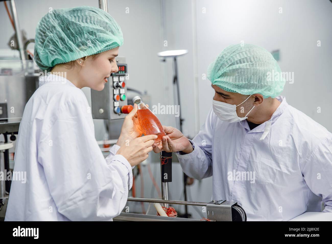 Food and drink factory ISO audit quality control team working, hygiene check and process standard inspection in plant production line. Stock Photo