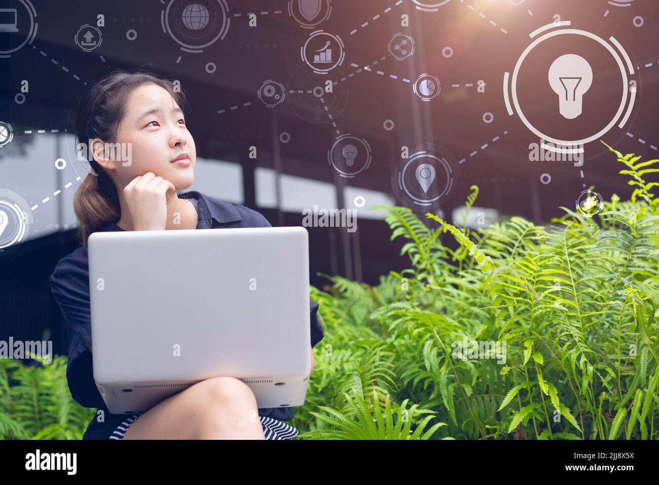 Young teen new generation businesswoman thinking business projects with green technology eco saving nature concept. Stock Photo