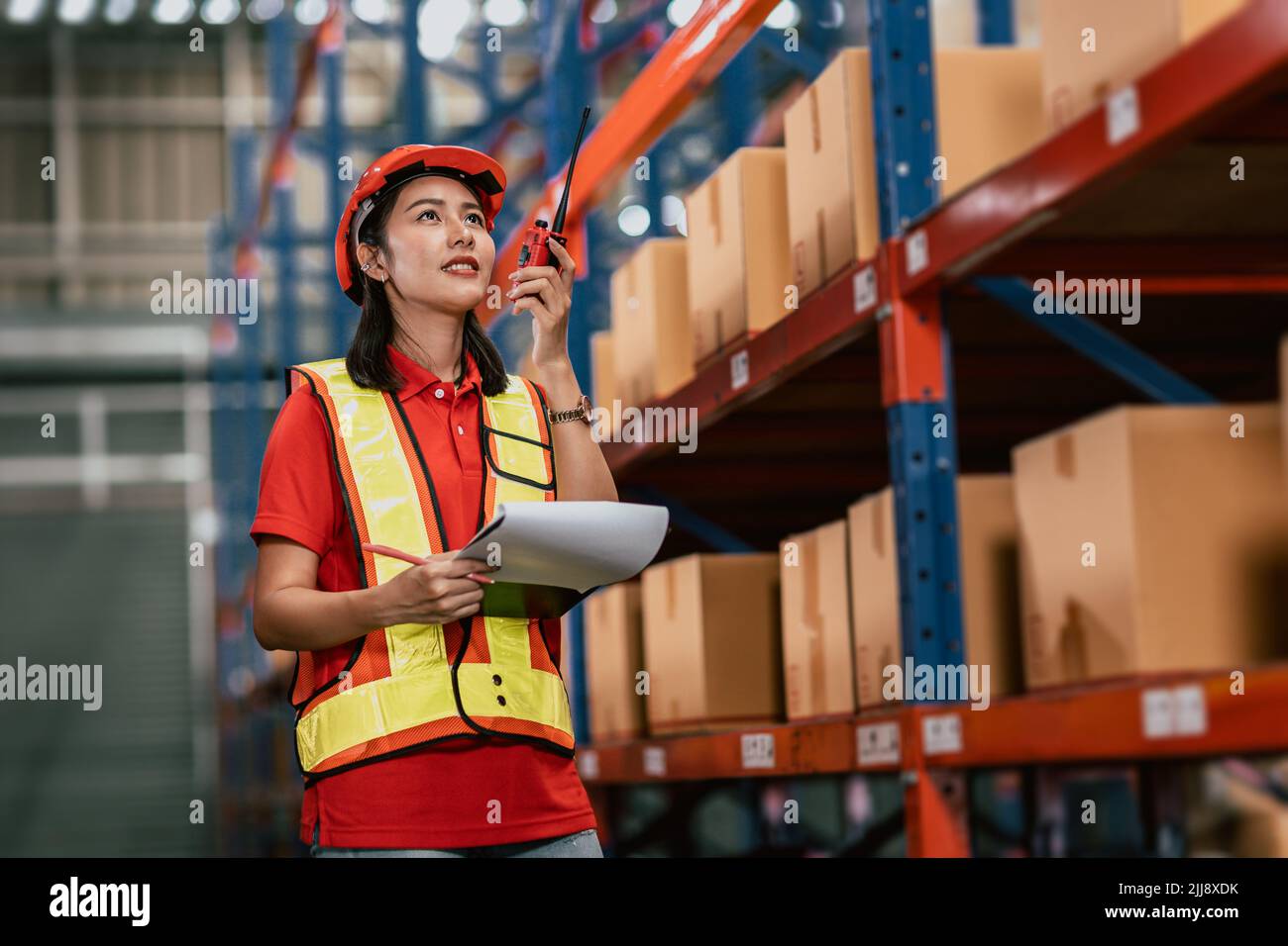 Warehouse woman staff worker cargo inventory products box store house with Asian worker Stock Photo