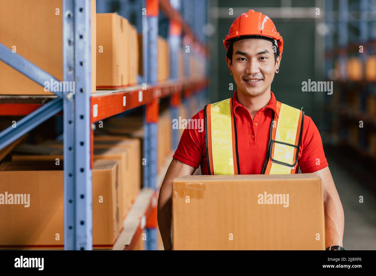 Warehouse staff worker at cargo inventory handle goods products box portrait happy smiling Stock Photo