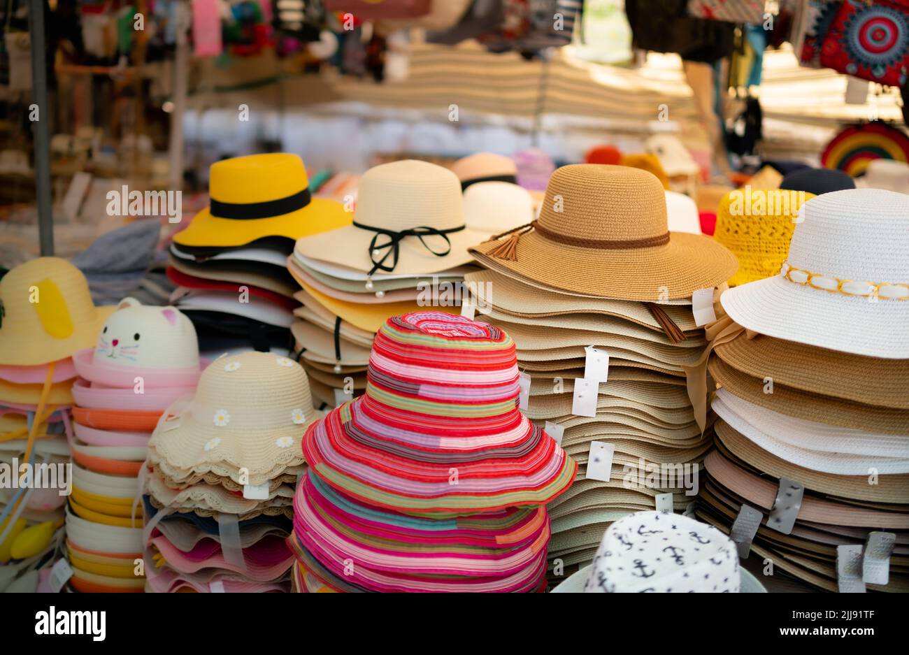 straw hats on sale at the street market Stock Photo Alamy