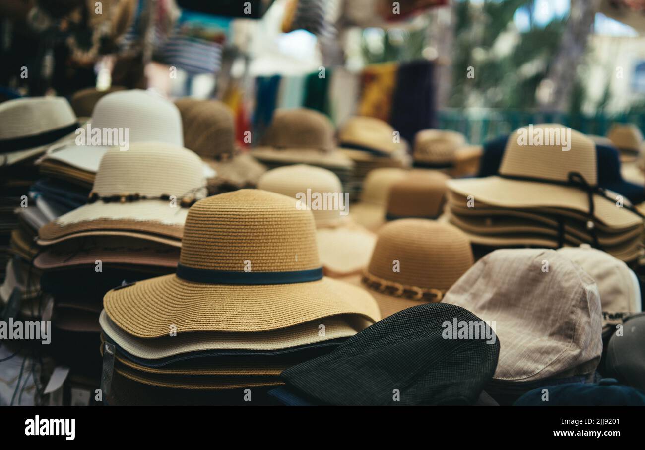 straw hats on sale at the street market Stock Photo Alamy