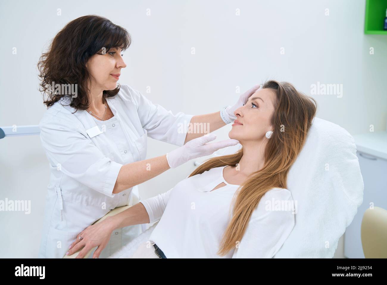 Dermatologist Examines The Skin Of The Patient Face Stock Photo Alamy