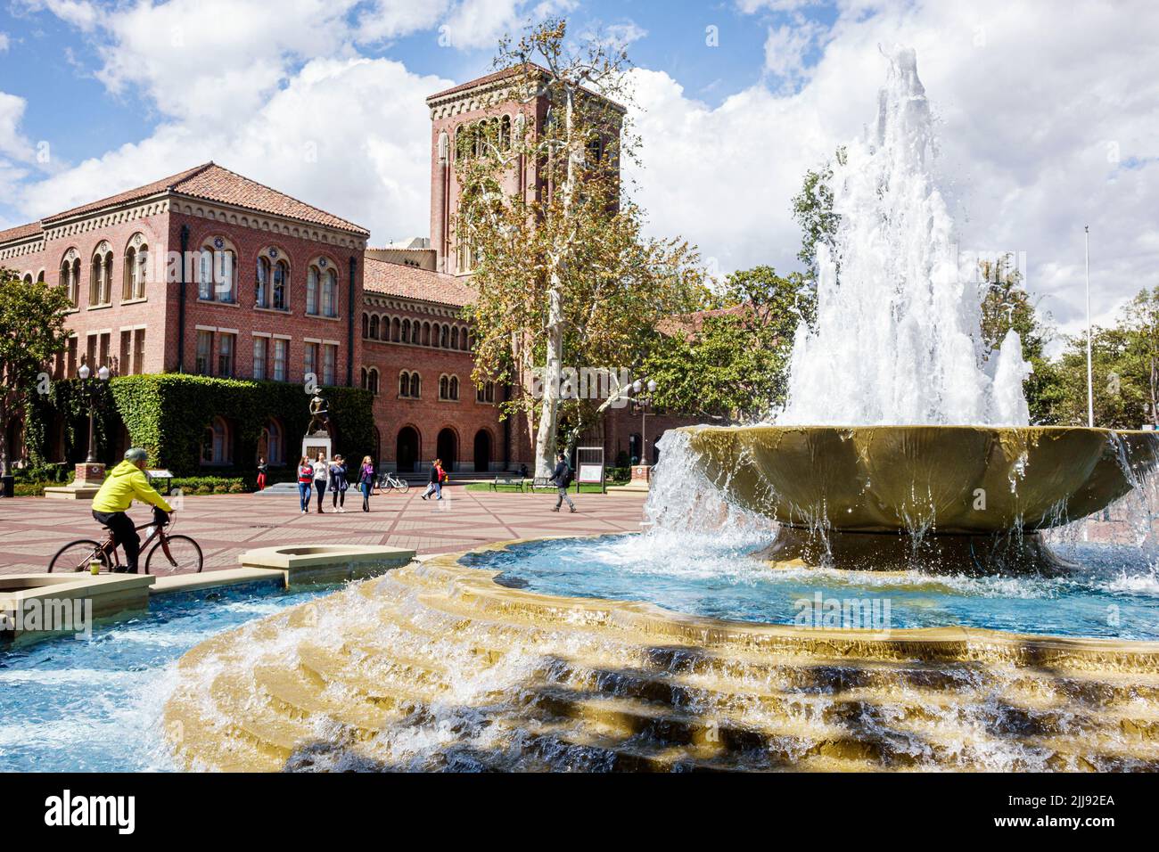 Los Angeles California,USC University of Southern California campus,Hahn Central Plaza Bovard Administration Building Shumway Fountain students biking Stock Photo