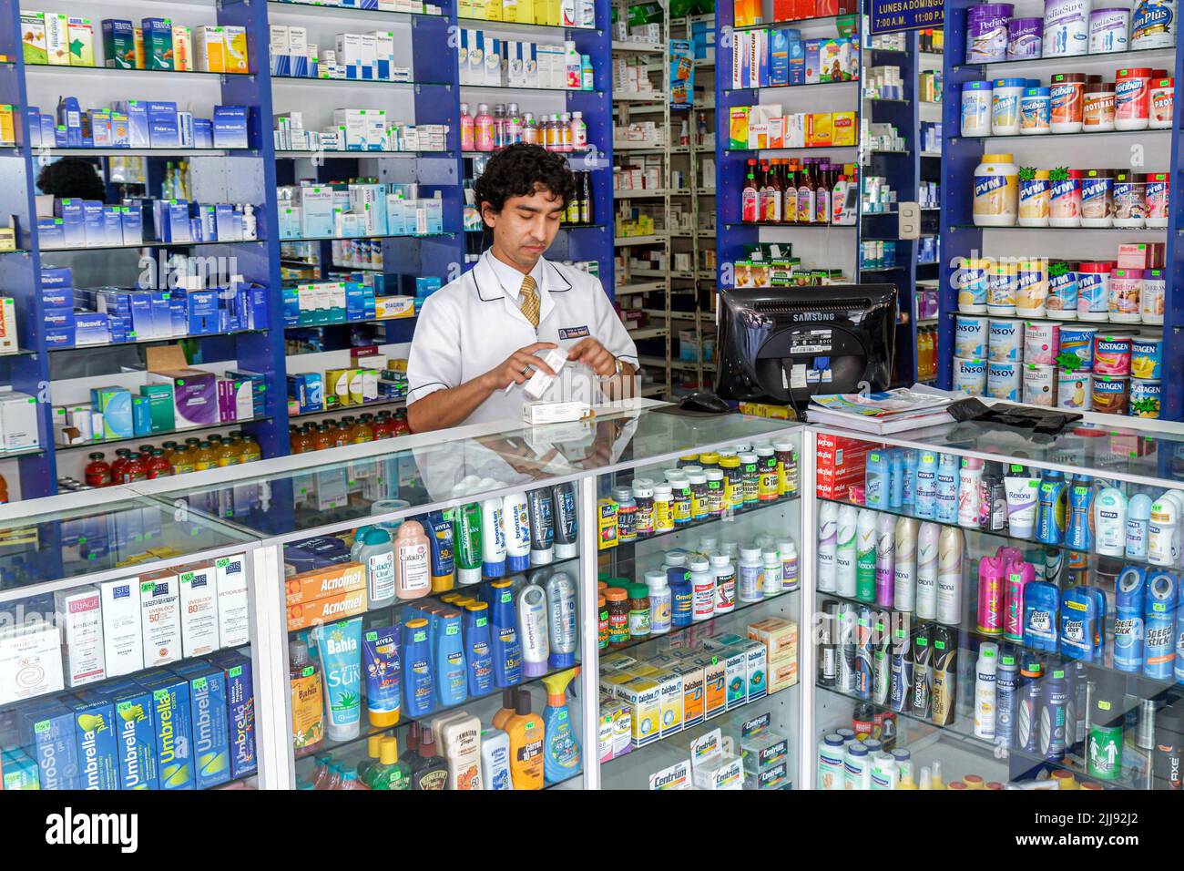 Tacna Peru,Calle San Martin,selling pharmacy drug store counter,Hispanic man pharmacist manager working worker,display sale OTC over the counter Stock Photo
