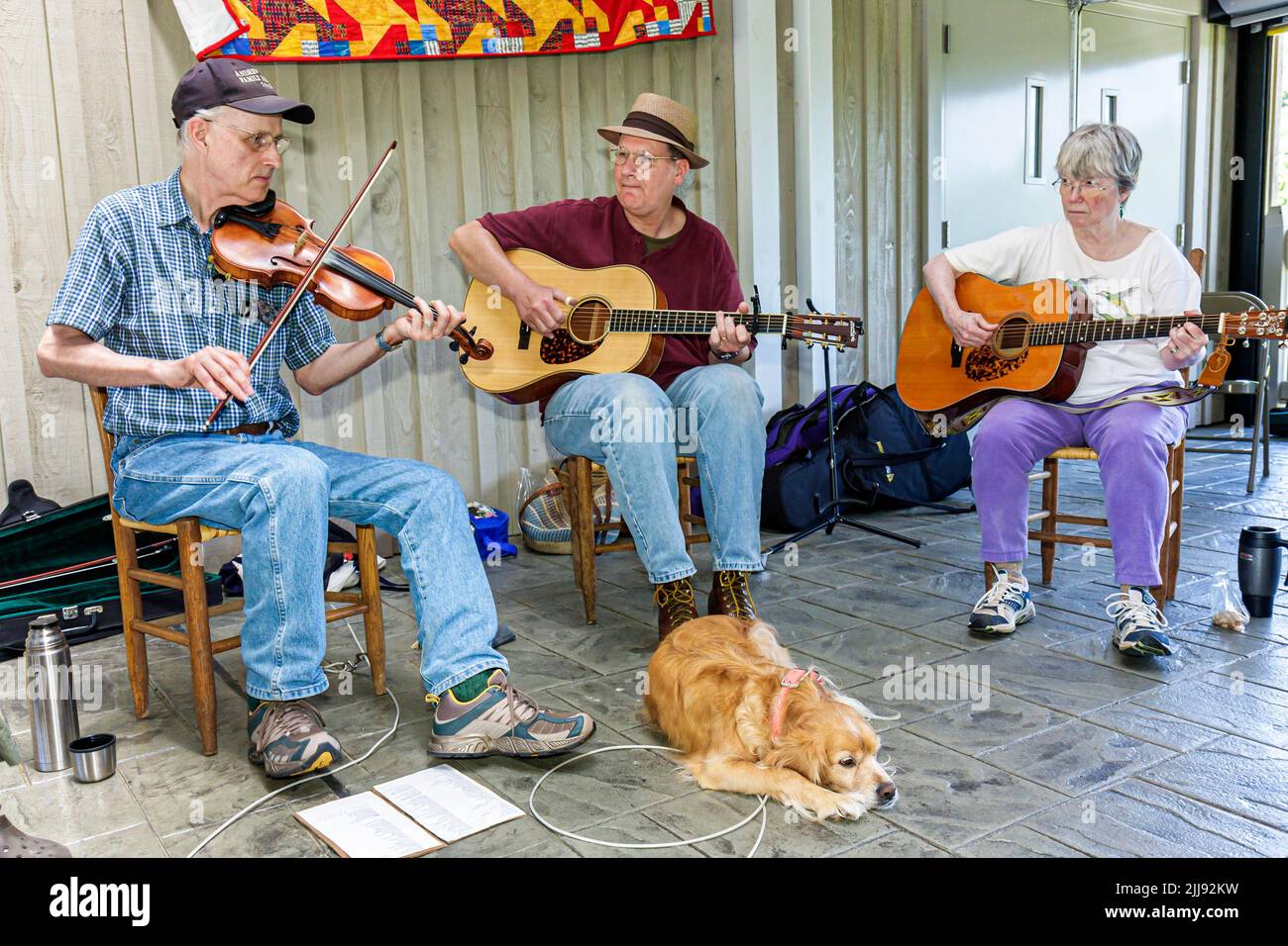 Blue Ridge Parkway Virginia,Blue Ridge Music Center Buck Mountain Band,country folk music men woman,dog musicians playing fiddle guitar culture group Stock Photo