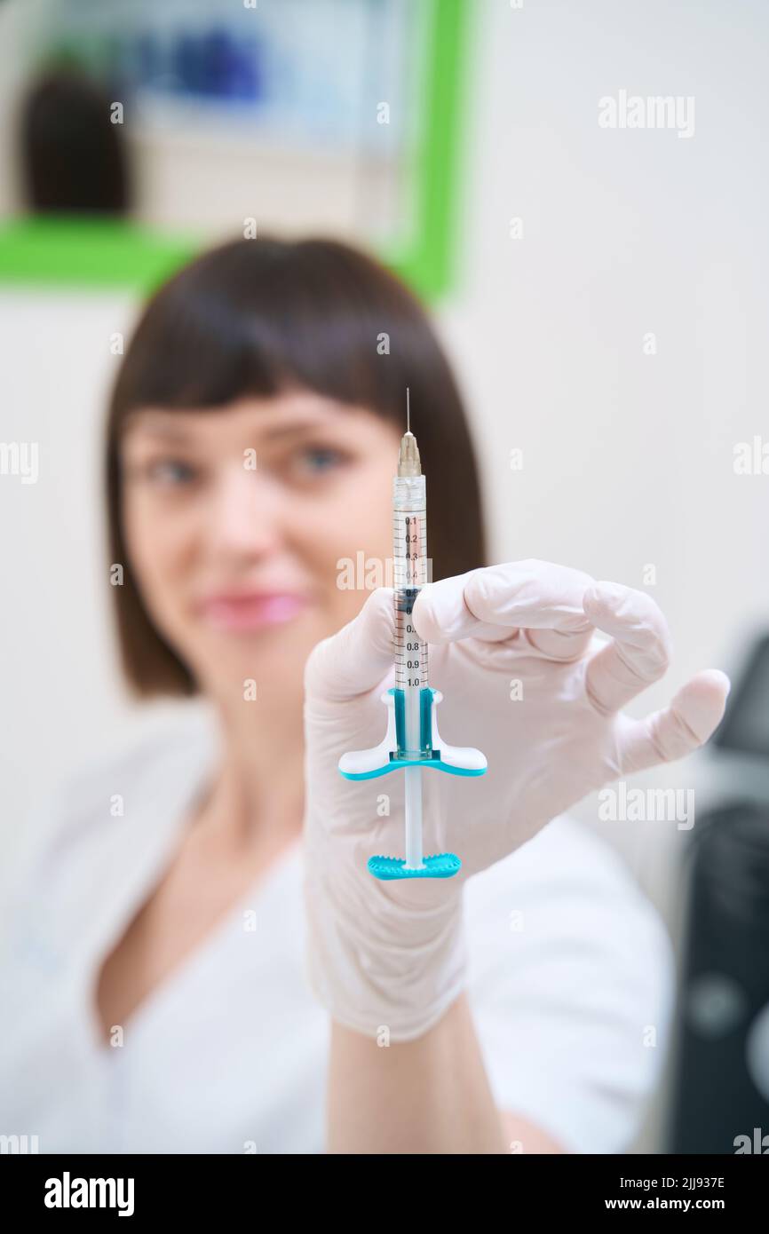 Syringe Injected Doctor with a syringe filled with injection Stock Photo - Alamy