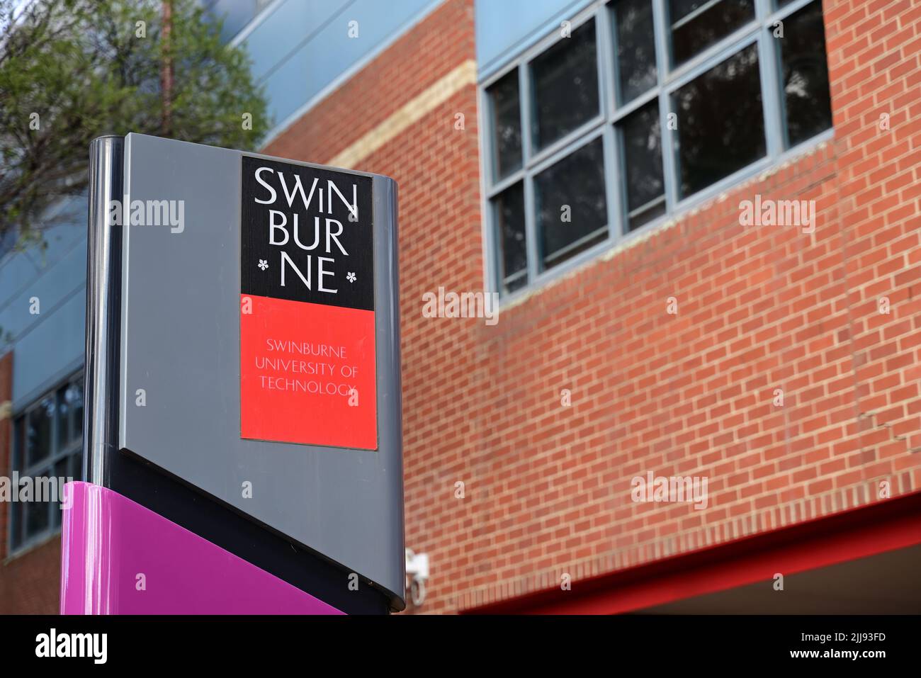 Swinburne University of Technology sign, outside a brick building at one of the university's Melbourne campuses Stock Photo