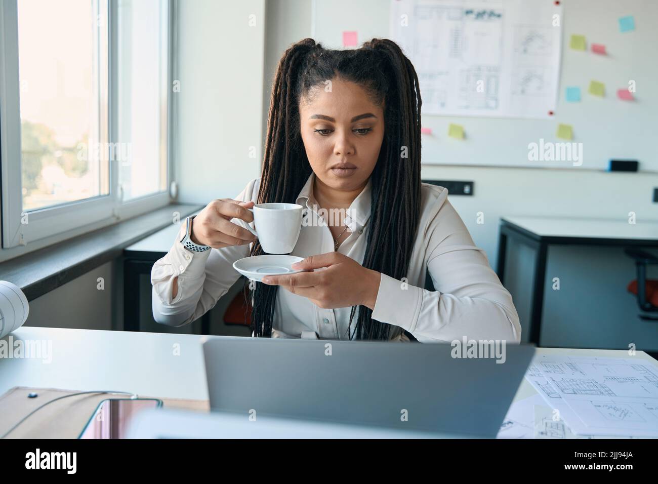 Serious female engineer working in her office Stock Photo