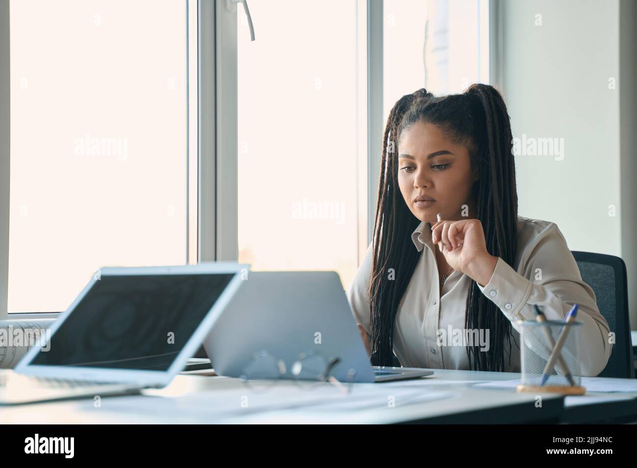 Focused design professional using her portable computer Stock Photo
