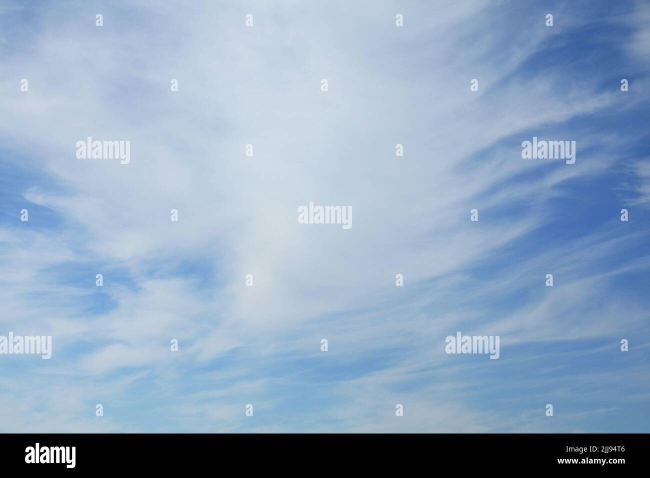 Cirrus clouds on the blue sky background. Thready and abstract sky pattern. Skies landscape i summer. Spindrift clouds and its texture. Tropospheric Stock Photo