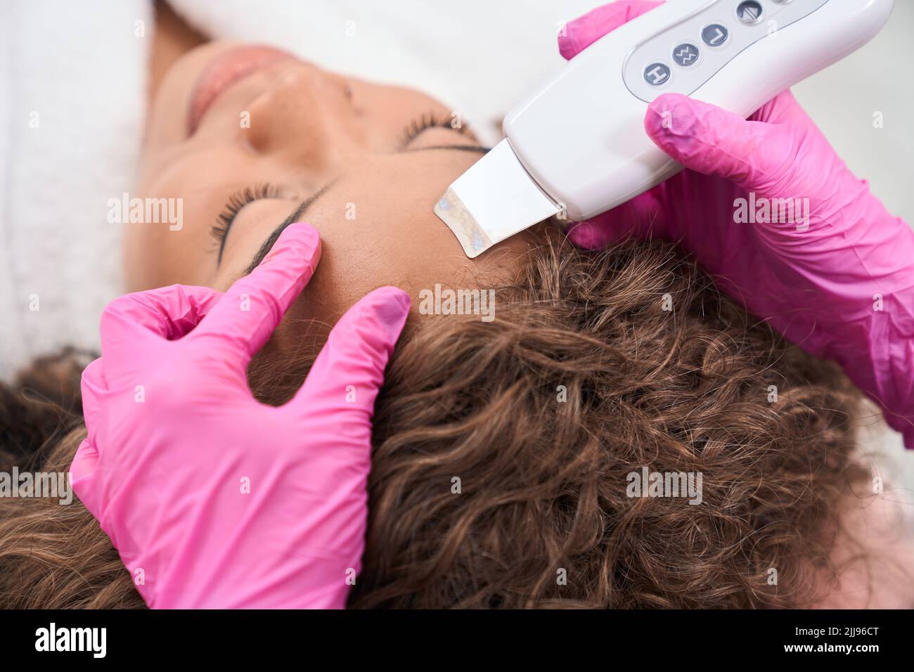 Patient on the procedure of hardware facial skin rejuvenation in clinic ...