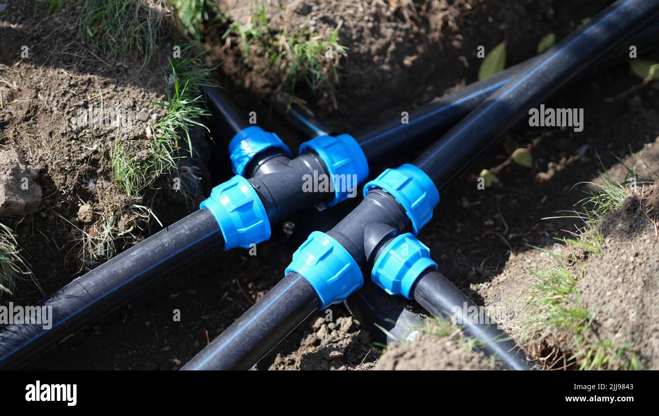Connecting HDPE plastic water pipes in garden closeup Stock Photo Alamy
