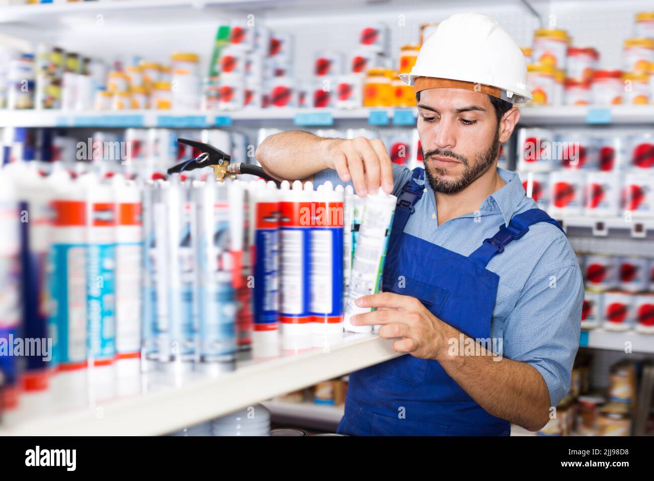 Concentrated handyman choosing materials Stock Photo