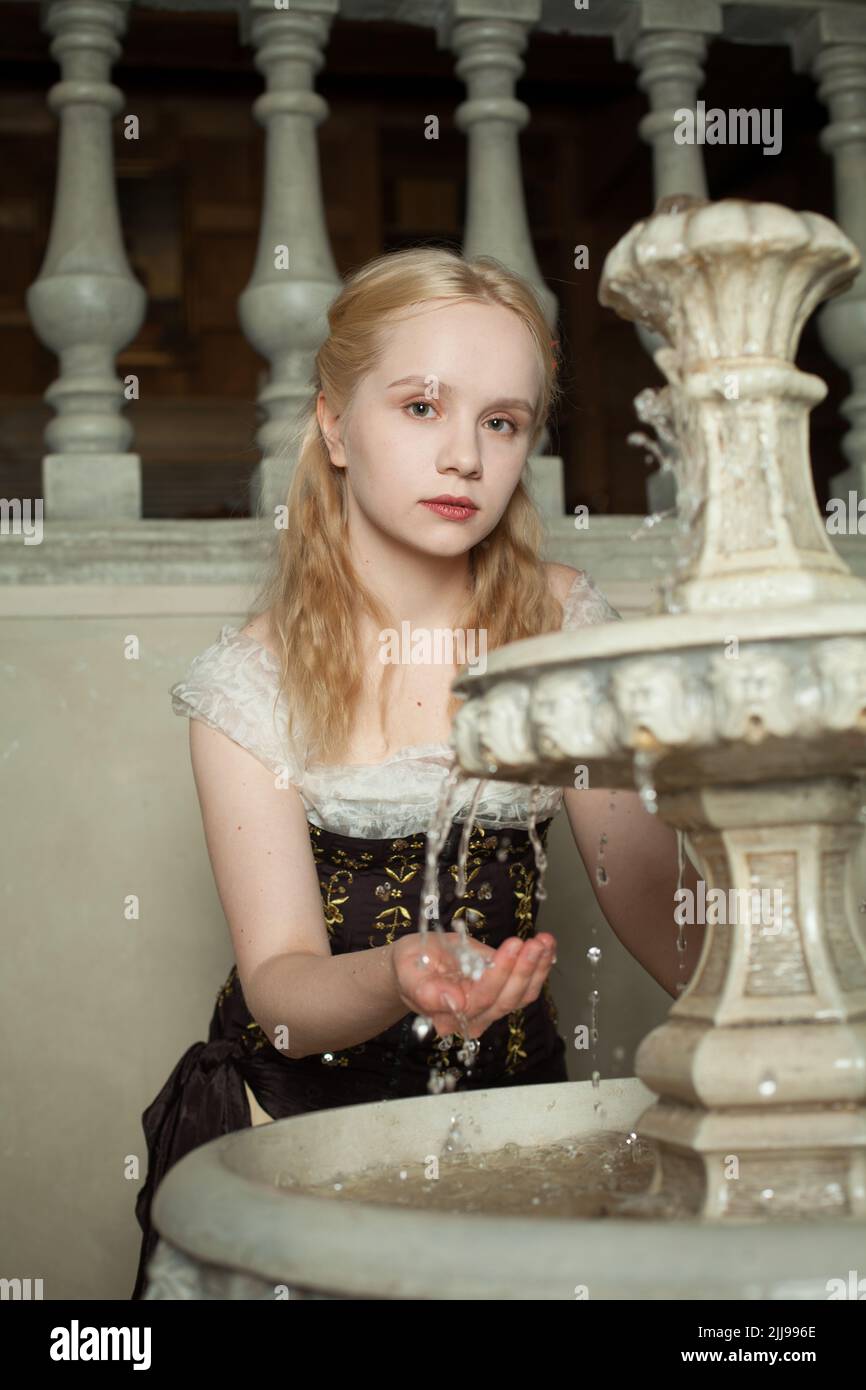 Young blonde woman at the fountain Stock Photo