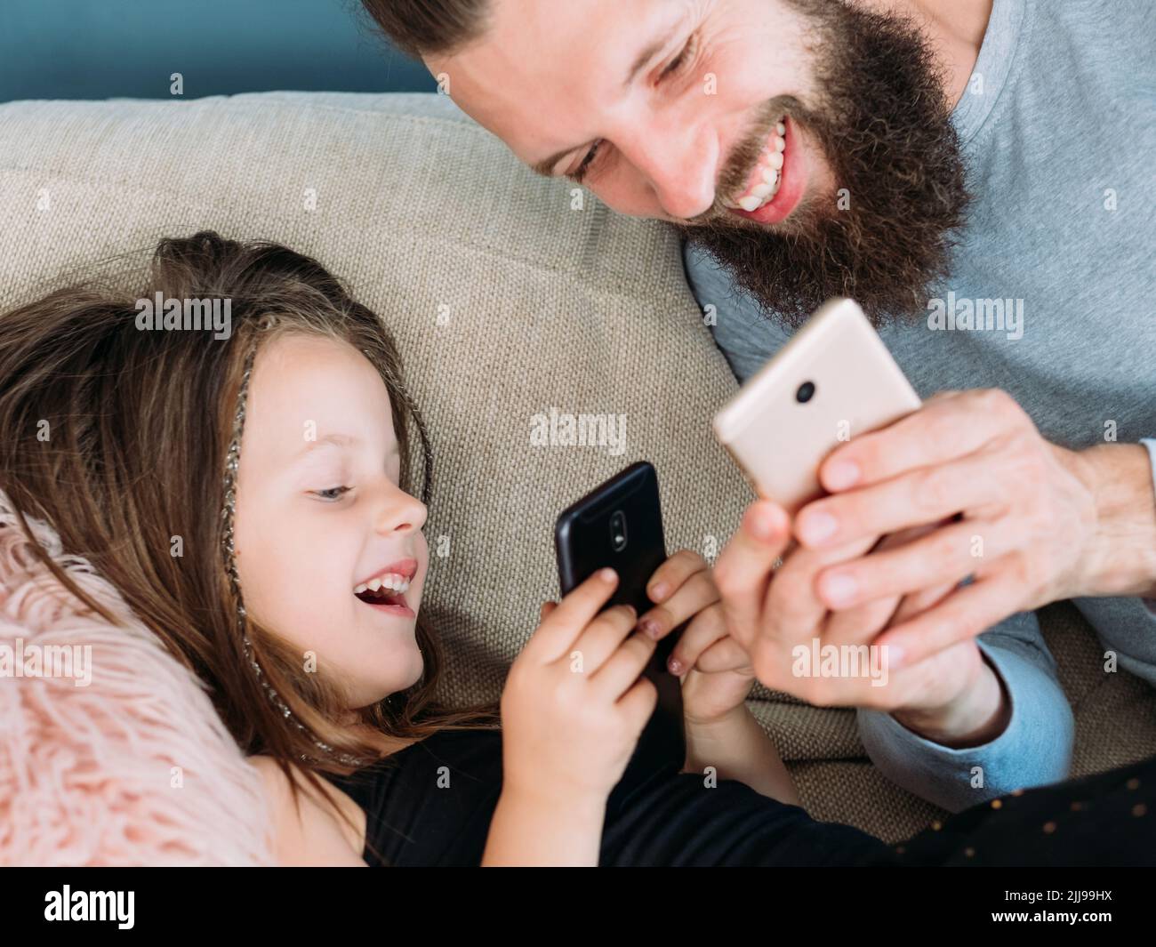 happy family leisure dad kid laugh together phone Stock Photo