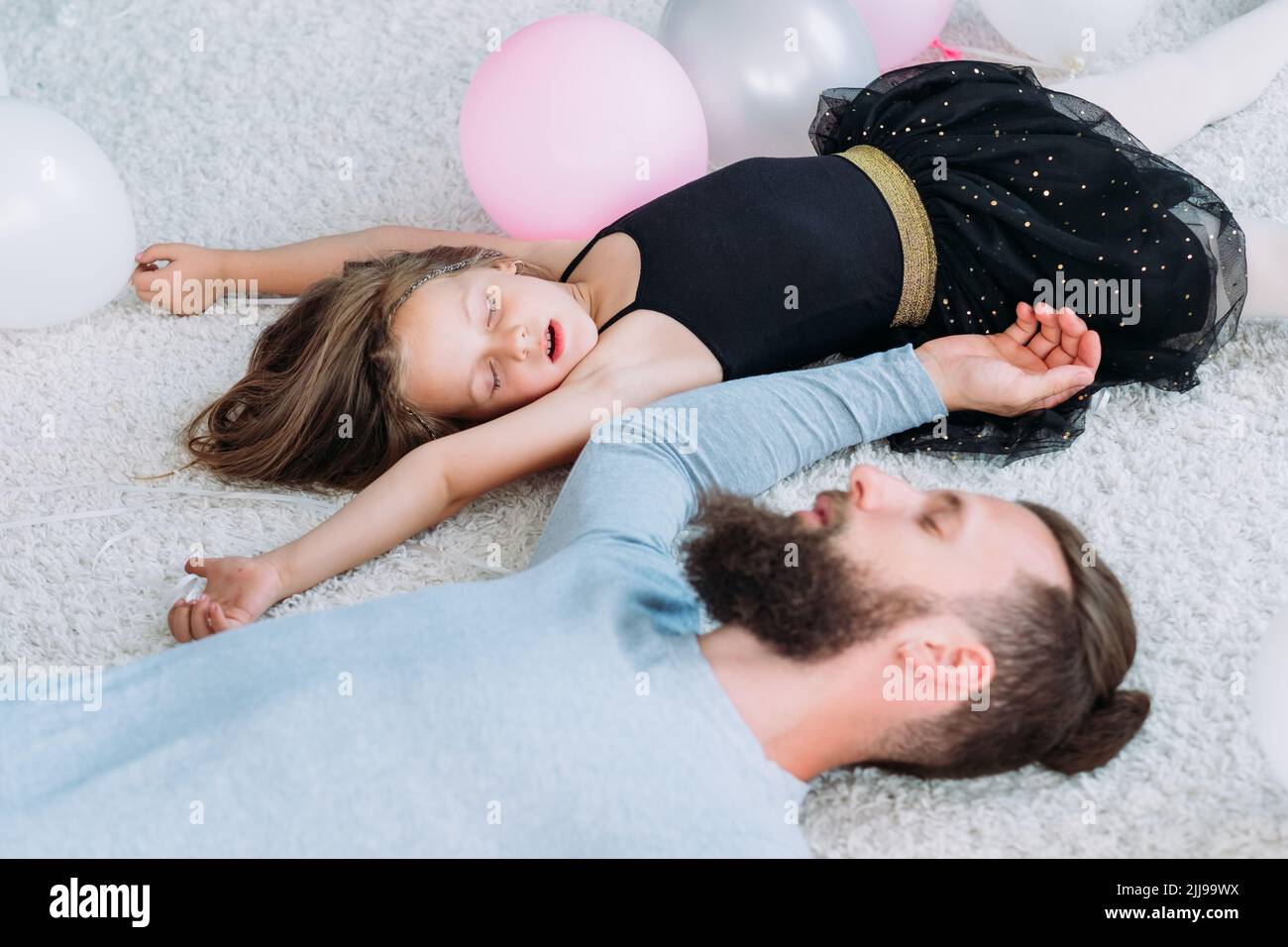 parenting lifestyle tired father asleep daughter Stock Photo