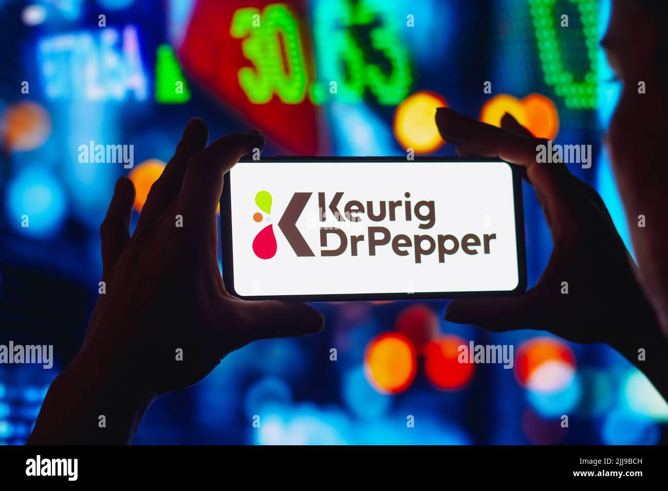 In this photo illustration, the Keurig Dr Pepper logo is displayed on a