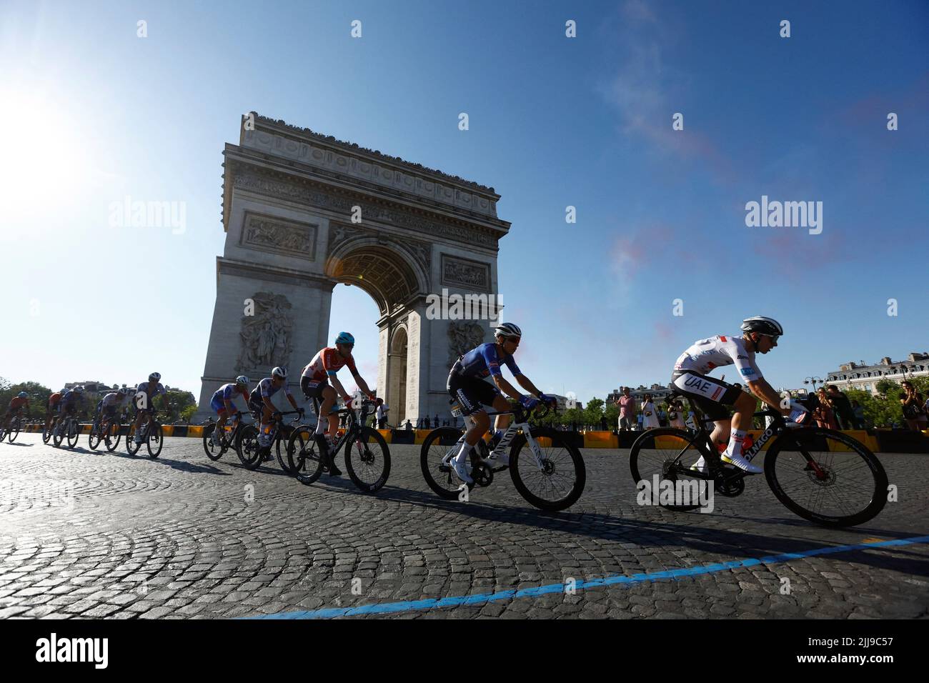 Cycling - Tour de France - Stage 21 - Paris La Defense Arena to Champs-Elysees - France - July 24, 2022 UAE Team Emirates' Tadej Pogacar in action with riders passing the Arc de Triomphe during stage 21 REUTERS/Gonzalo Fuentes Stock Photo