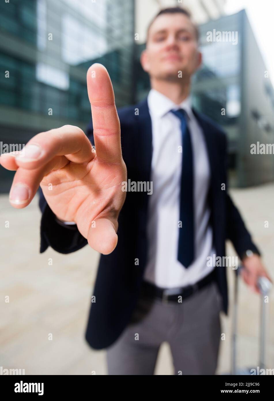 Office worker with suitcase asking companion to wait Stock Photo - Alamy