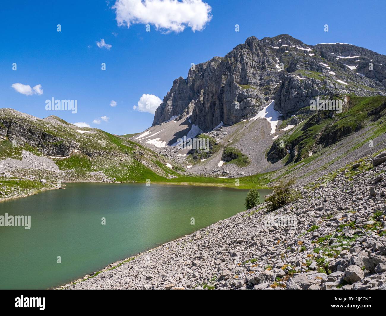 The inaccessible north face of Mount Astraka and Xerolimni lake in the Pindus Mountains of northern Greece Stock Photo