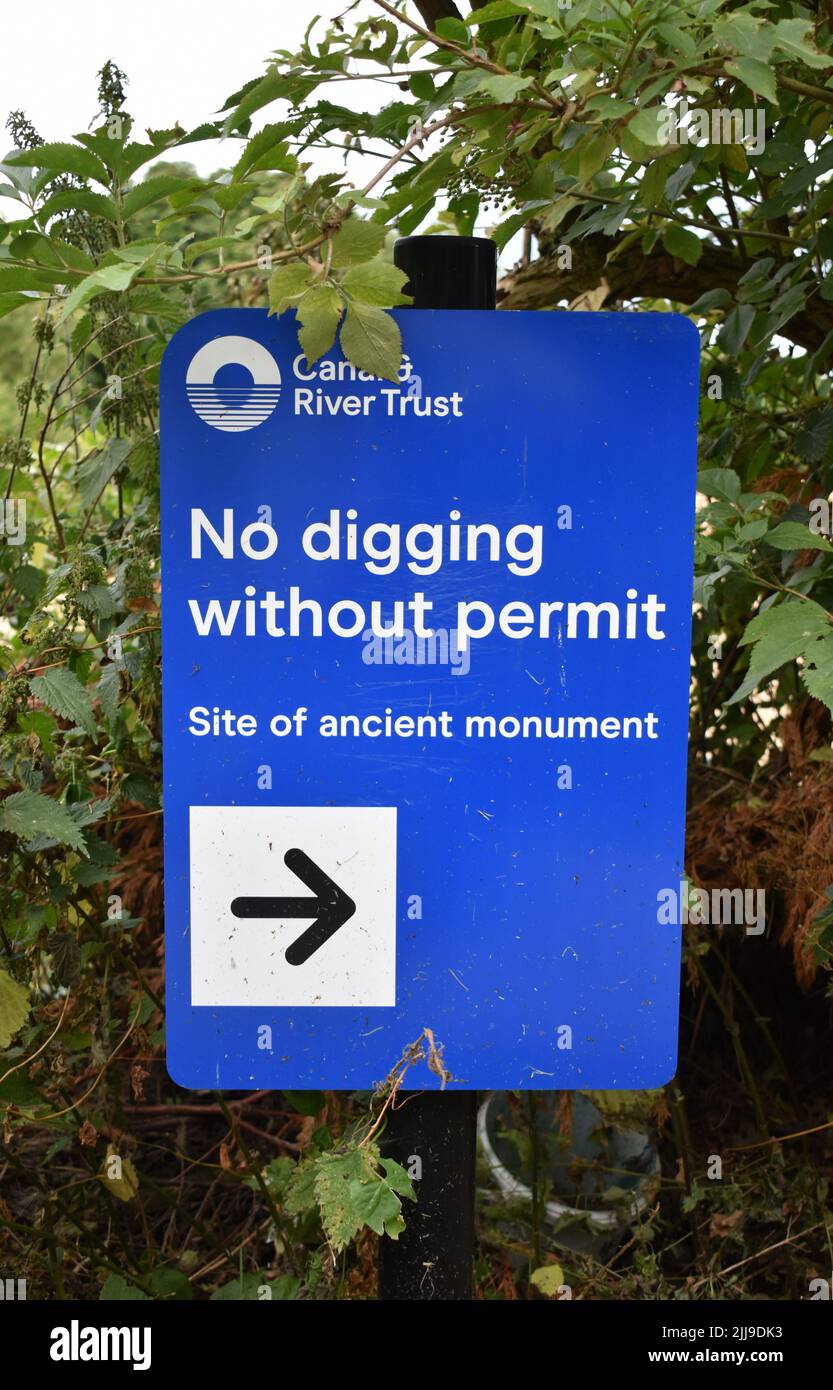 Sign by Canal & River Trust: 'No digging without permit. Site of ancient monument'. Stock Photo