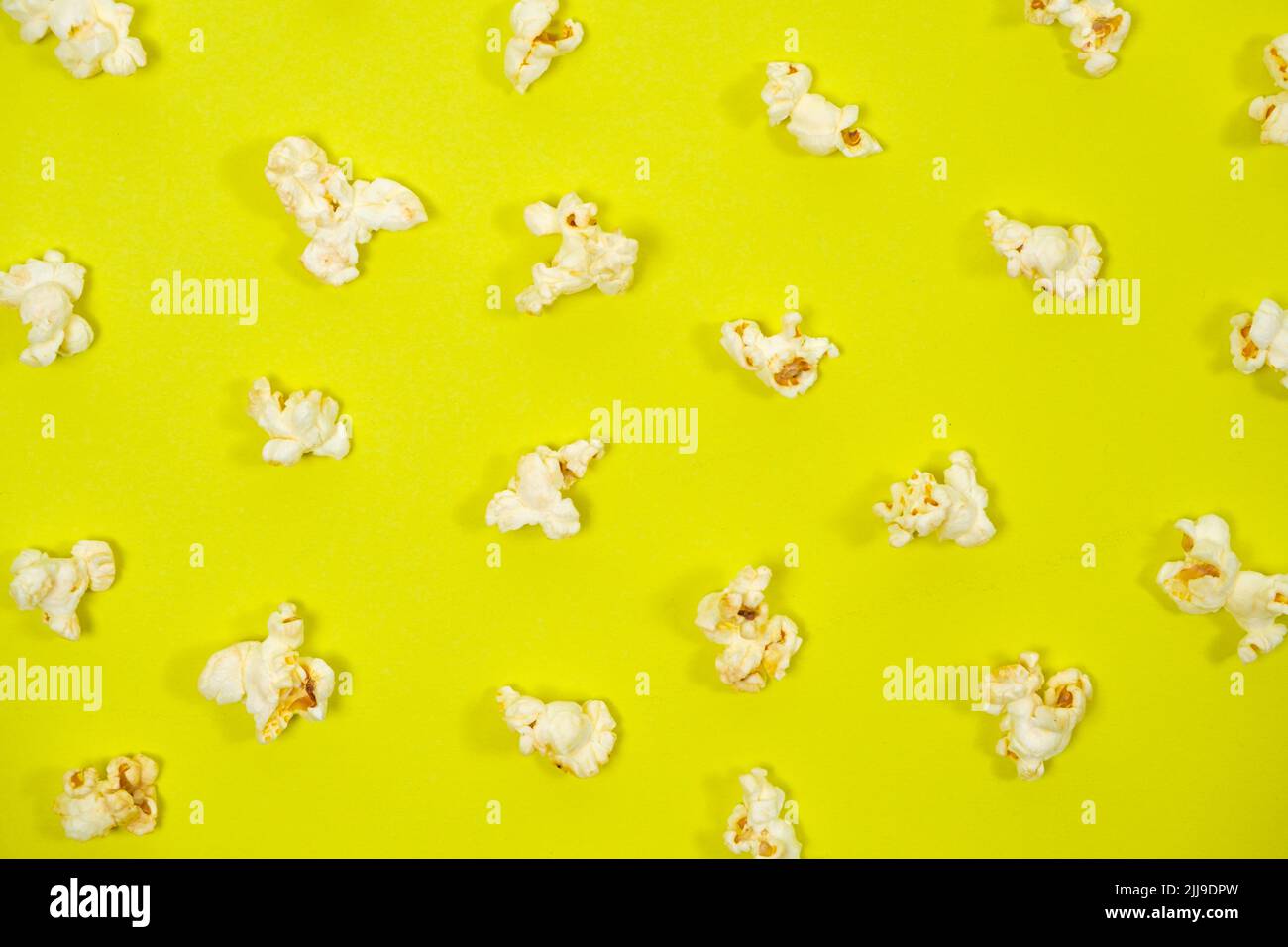 Popcorn on a yellow background, close-up view from above Stock Photo