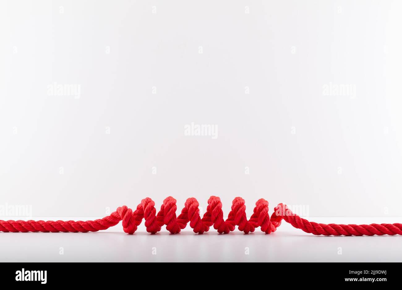 Red rope with a spiral Isolated on white background. Red colorful lasso