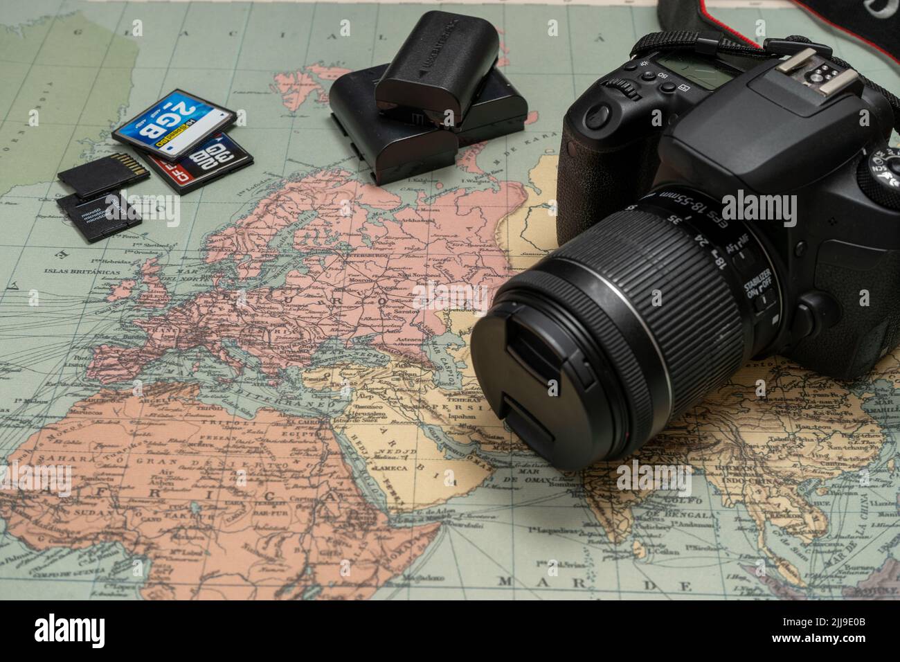Go on an adventure. The map and the camera on a wooden table. Top view. Stock Photo
