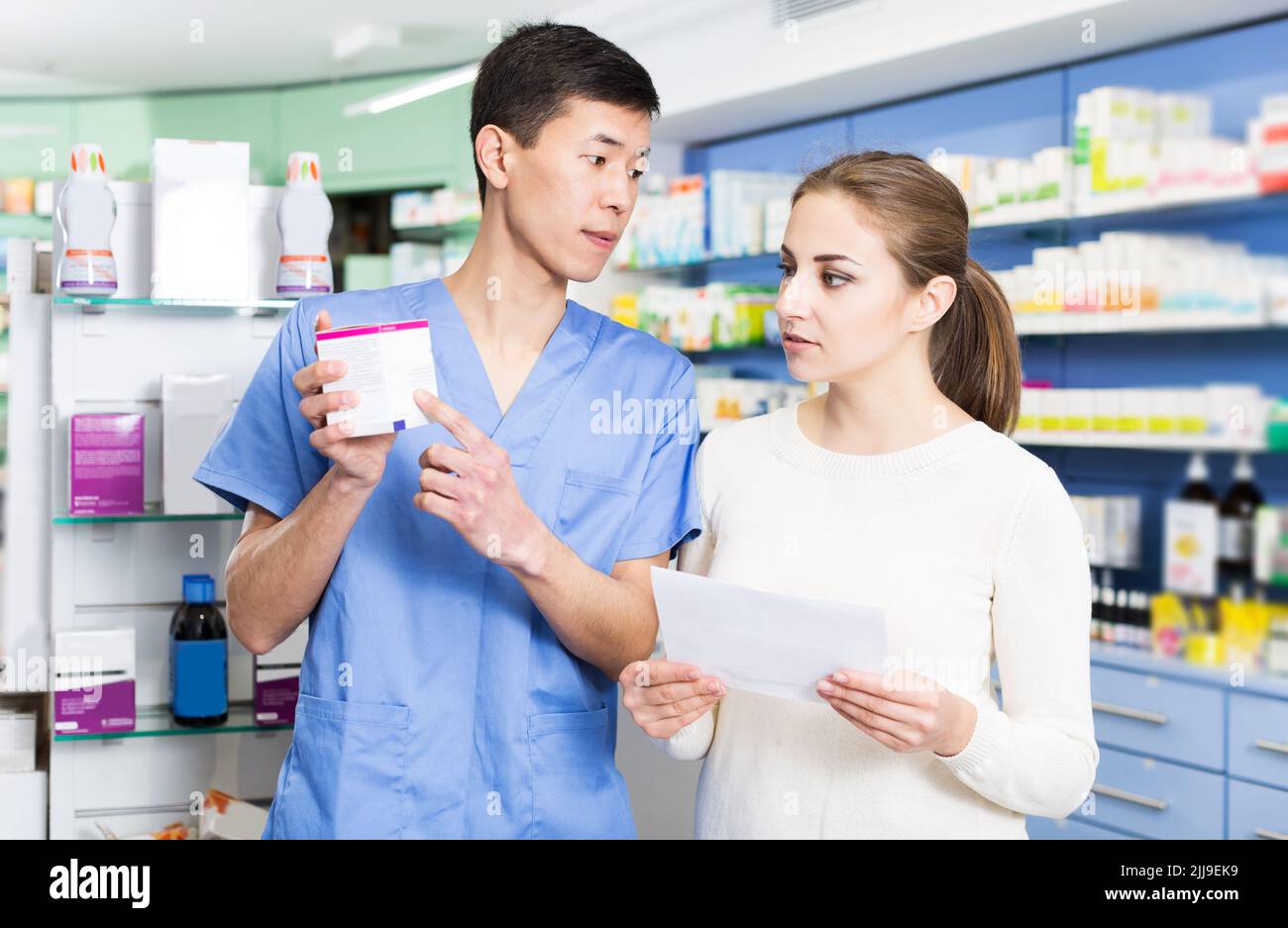 Japanese specialist helping client choose medicine Stock Photo Alamy