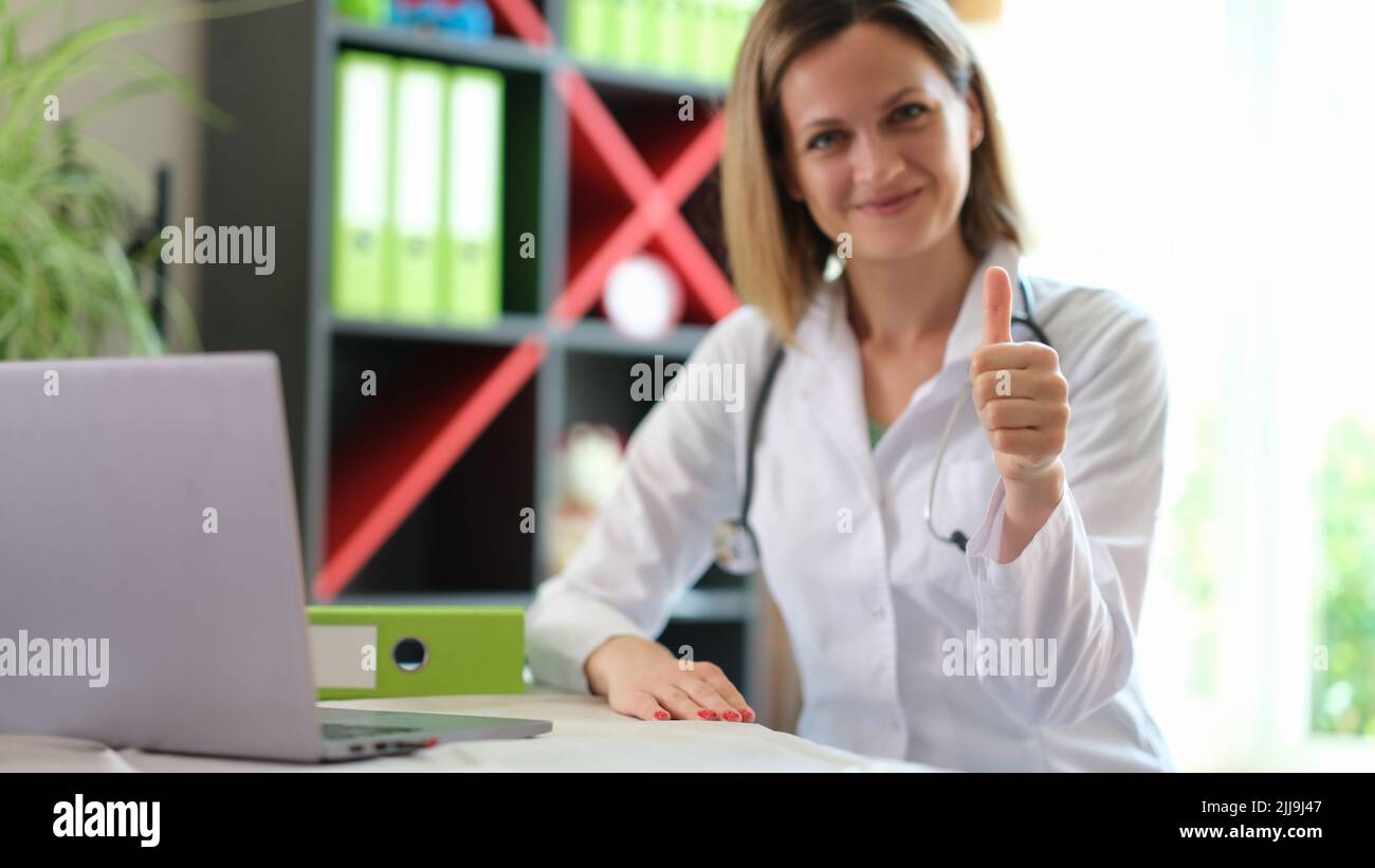 Happy smiling female practitioner showing thumb up gesture Stock Photo