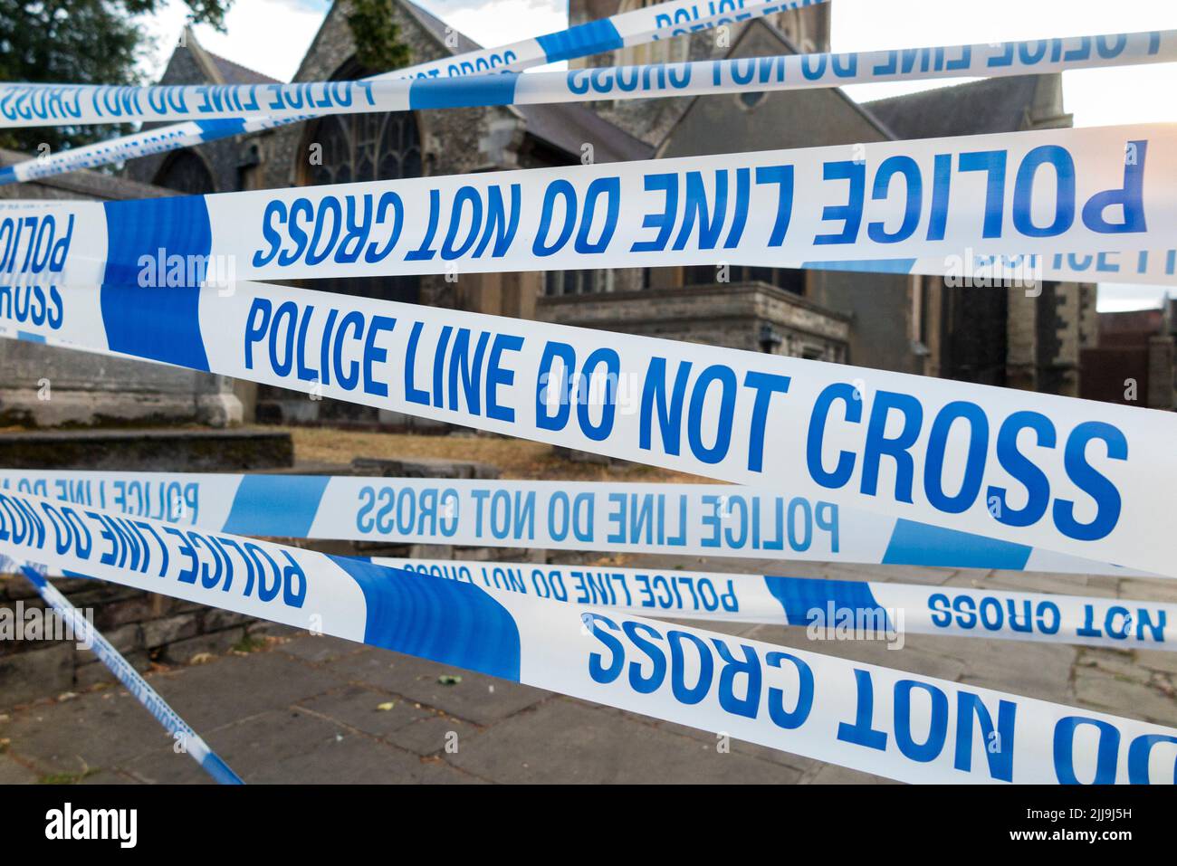 Police Line Do Not Cross tape barrier, typically placed around a crime