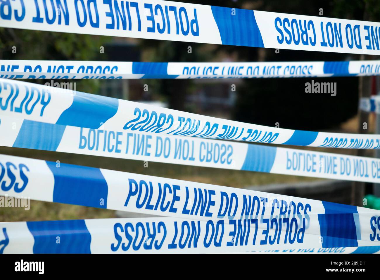 Police Line Do Not Cross tape barrier, typically placed around a crime