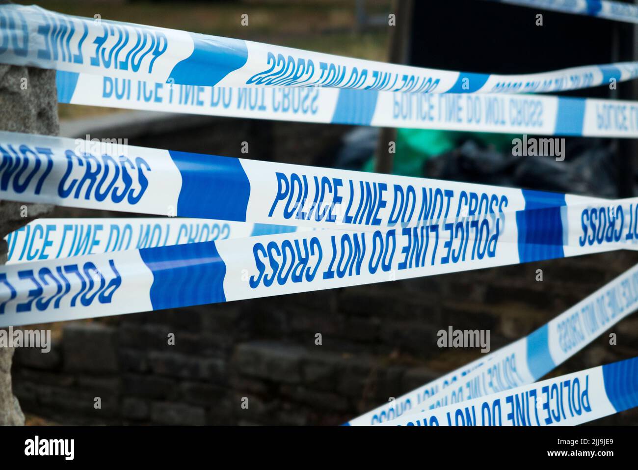 Police Line Do Not Cross tape barrier, typically placed around a crime